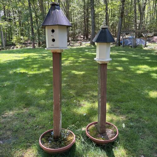 2 Decorative Wooden Birdhouses on Posts with Metal Roofs and Planter Bases