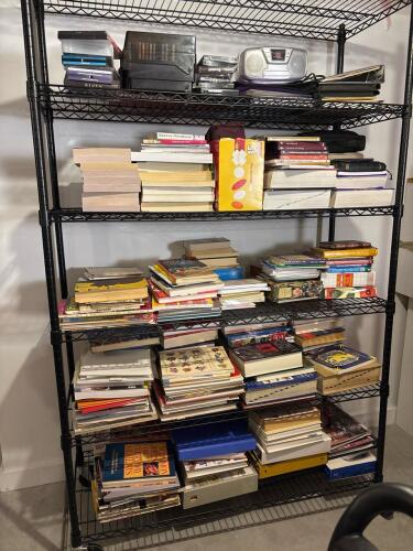 Steel Wire Utility Rack with Assorted Books, DVRs and Electronics