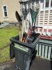 Assorted Lawn Tools in Trash Bin
