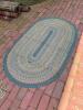 Braided Oval Rug and Small Worn Geometric-Patterned Rug - 5