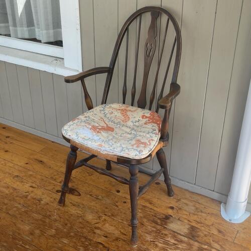 Windsor-Style Wooden Armchair With Worn Animal Cushion
