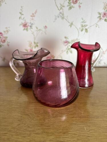 Three Hand Blown Cranberry-Style Glass Pitchers and Vase