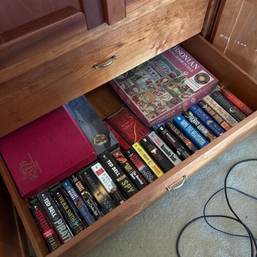 Assorted Paperback Novels and Jigsaw Puzzles